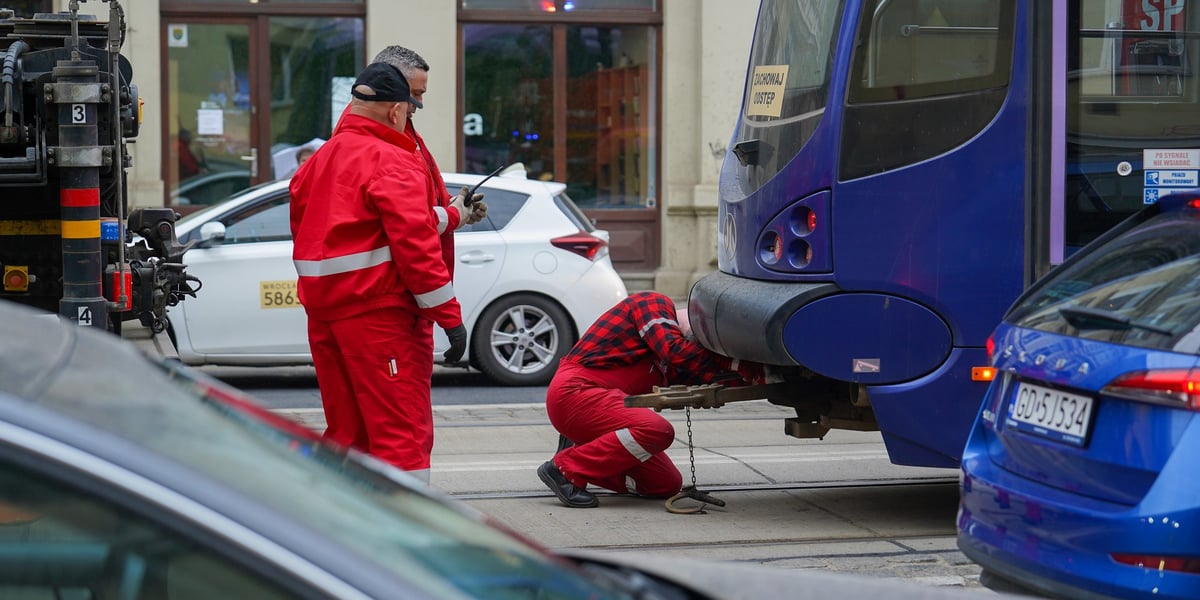 Dwóch pracowników sprawdza stan tramwaju