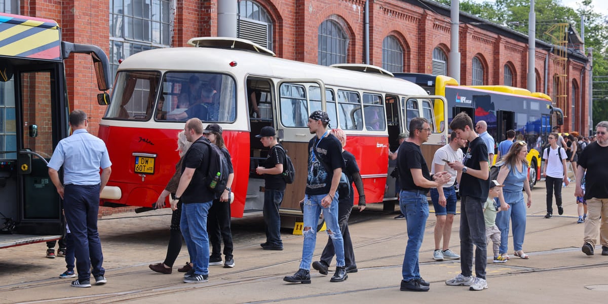 Zabytkowy autobus przed halą zajezdni ora mieszkańcy na Dniu Otwartym MPK Wrocław w zajezdni Borek, 23.05.2026.