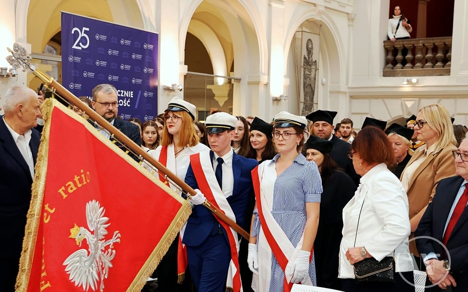 Studenci wnoszą sztandar czerwony z białym orłem 
