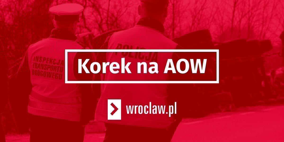 Czerwona plansza z białą ramką z napisem "korek na AOW"