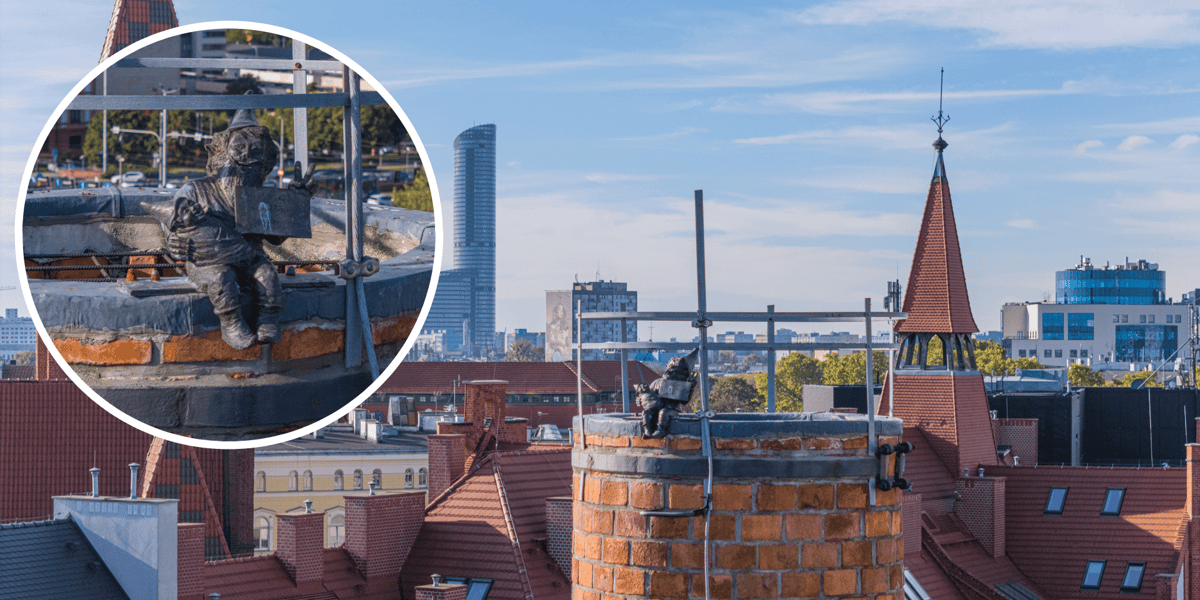 Widok na panoramę Wrocławia i komin na Bulwarze Staromiejskim, na którym są umieszczone krasnale. Na zdjęciu w kółku widać krasnala, który trzyma dziecko - krasnoludka w beciku, na rękach 