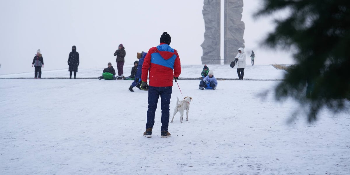 Ludzie na Górce Oporowskiej z sankami, jabłkami, czworonogami
