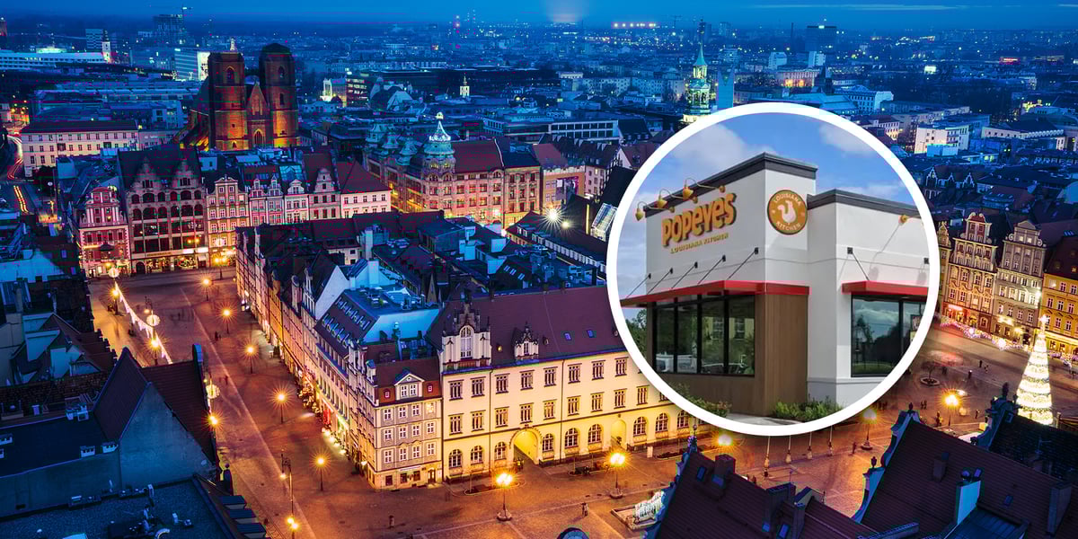 Panorama Wrocławia i logo Popeyes. Pierwsze w Polsce restauracja Popeyes otworzy się we Wrocławiu. 