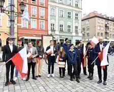 Prezydent Wrocławia Jacek Sutryk rozdaje flagi mieszkańcom i turystom.