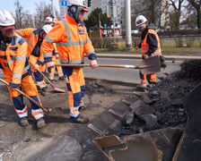 Układanie masy bitumicznej na ulicy Powstańców Śląskich między Orlą a Krzycką