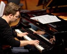 <p>Piotr Alexewicz podczas próby w sali czerwonej Narodowego Forum Muzyki</p>