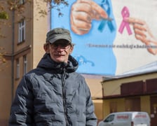 <p>Wojtek Miszewski na tle muralu</p>