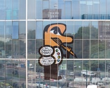 Fragment jubileuszowej grafiki na budynku CSU (ASP Wrocław) na Traugutta, przedstawiającej malarza z pędzlem w dłoni (8 września 2026)
