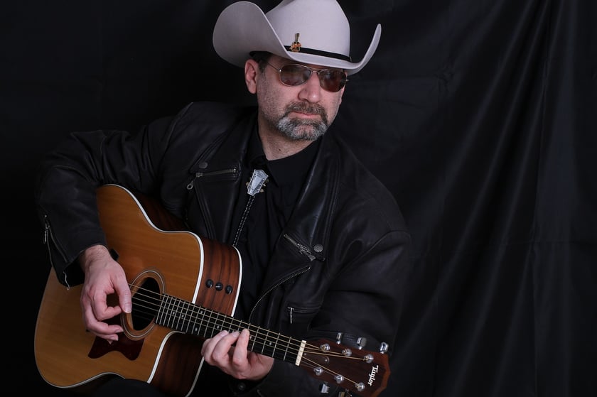 Polski Dzień Muzyki Country. Na zdjęciu gitarzysta w kowbojskim kapeluszu i okularach.