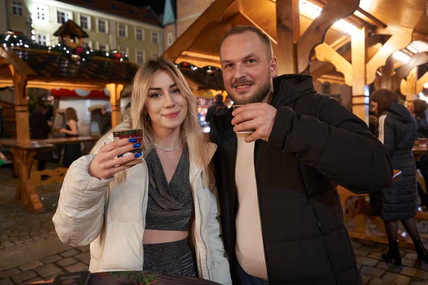 Sylwester 2022 na wrocławskim Rynku. Na zdjęciu widać ludzi, którzy w ostatnią noc 2022 roku bawili się na Jarmarku Bożonarodzeniowym we Wrocławiu
