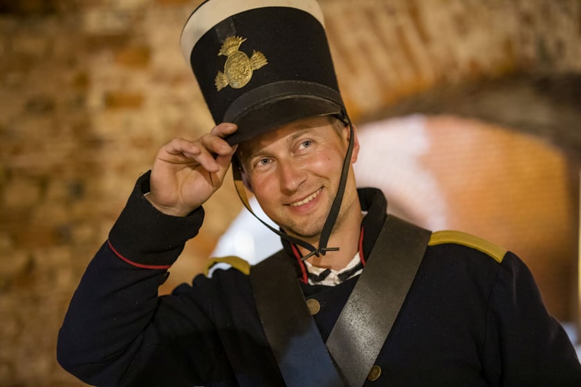 Przewodnicy oprowadzają turyst&oacute;w w historycznych mundurach i strojach.&nbsp;