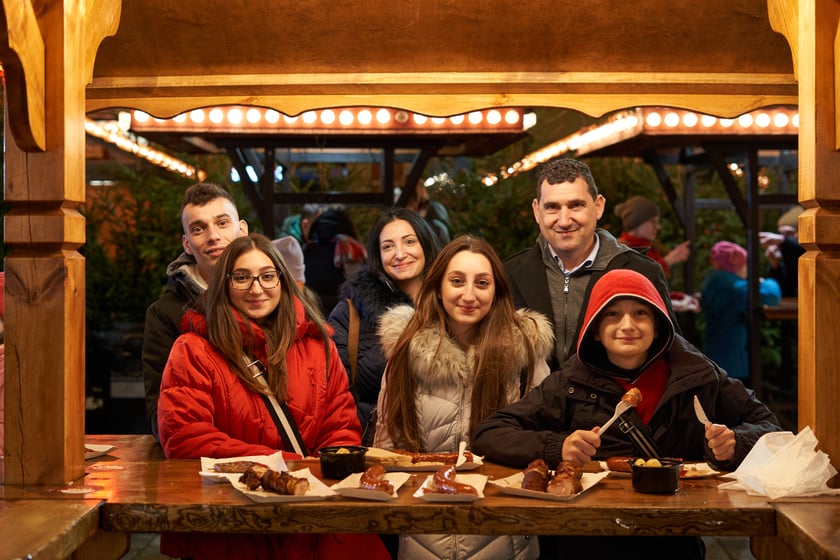 Sylwester 2022 na wrocławskim Rynku. Na zdjęciu widać ludzi, którzy w ostatnią noc 2022 roku bawili się na Jarmarku Bożonarodzeniowym we Wrocławiu