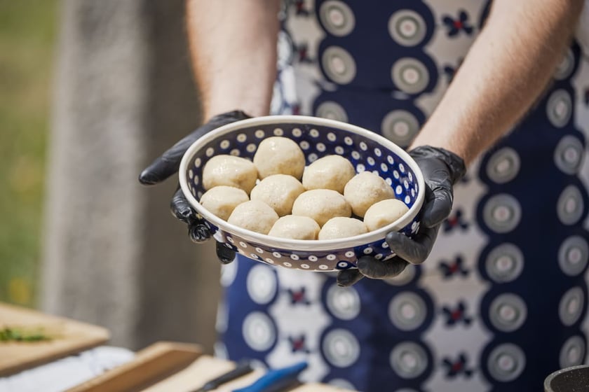 Kamila Kokot i Tomasz Sielicki pokazują, jak ugotować kluski wrocławskie. Zdjęcie wykonano 23 lipca 2025 na Ostrowie Tumskim, w trakcie kręcenia filmu.