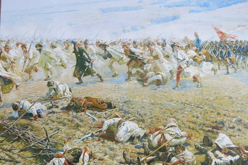 Fragment Panoramy Racławickiej &ndash; kosyniarzy w ataku są wspierani przez oddziały 6 Regimentu Pieszego. Wśr&oacute;d nich generał ziemiański Jan Ślaski.