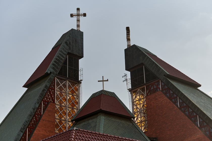Kości&oacute;ł pw. Chrystusa Kr&oacute;la budowany był w latach 1978-1991 na planie kwadratu. Budowla przypomina ostrosłup złożony z czterech części, podobnych do wież, o zr&oacute;żnicowanej wysokości. Zbiegające się &nbsp;ku środkowi ściany owych wież przykrywają centralną (sakralną) część budowli, nadając jej ekspresyjny charakter. Nachylone połacie zdobi dekoracja przypominająca strukturę kryształu. W przyziemiu mieści się kaplica św. Mikołaja, ośrodek kultury i szkoła.