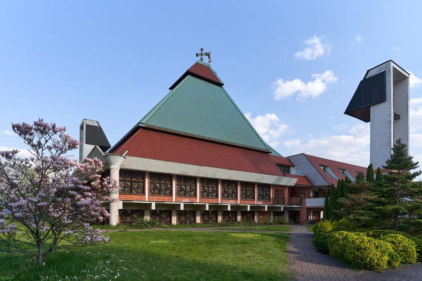 Kości&oacute;ł pw. Chrystusa Kr&oacute;la budowany był w latach 1978-1991 na planie kwadratu. Budowla przypomina ostrosłup złożony z czterech części, podobnych do wież, o zr&oacute;żnicowanej wysokości. Zbiegające się &nbsp;ku środkowi ściany owych wież przykrywają centralną (sakralną) część budowli, nadając jej ekspresyjny charakter. Nachylone połacie zdobi dekoracja przypominająca strukturę kryształu. W przyziemiu mieści się kaplica św. Mikołaja, ośrodek kultury i szkoła.