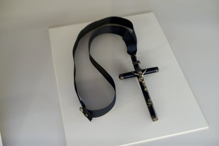 Krzyż z figurką Chrystusa na rypsowej wstążce. Wystawa &bdquo;Czarna sukienka. Patriotki w walce o wolność&rdquo;&nbsp;