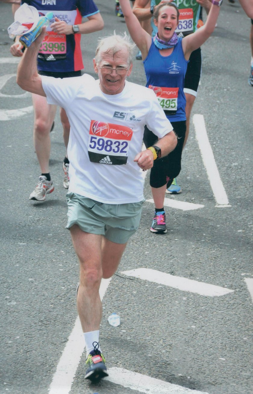 Biegnący zawodnicy podczas maratonu. Zbliżają się do mety, unoszą ręce w geście zwycięstwa. Na pierwszym planie starszy mężczyzna, prof. Jan Chmura, na drugim planie  młoda kobieta.