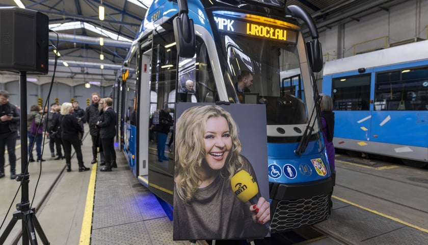 Na zdjęciu: zdjęcie uśmiechniętej Moniki Jaworskiej, ustawione przed tramwajem jej imienia