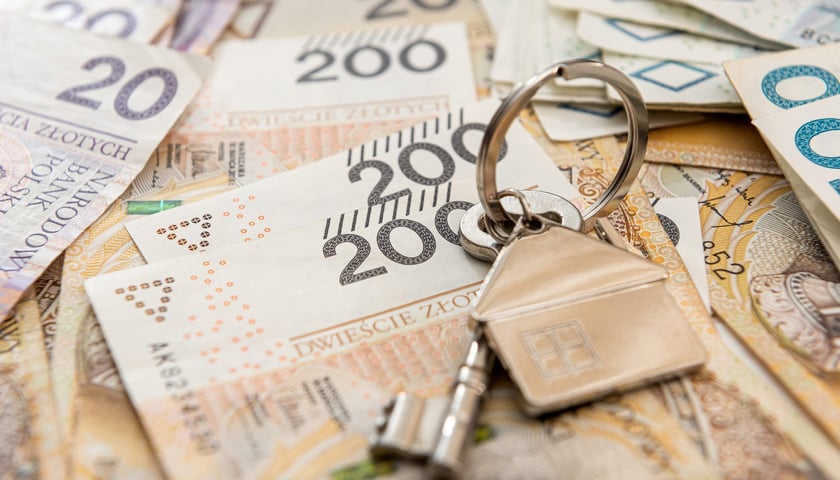 Stopy procentowe w Polsce - na zdjęciu ilustracyjnym banknoty i złoty klucz do domu/mieszkania