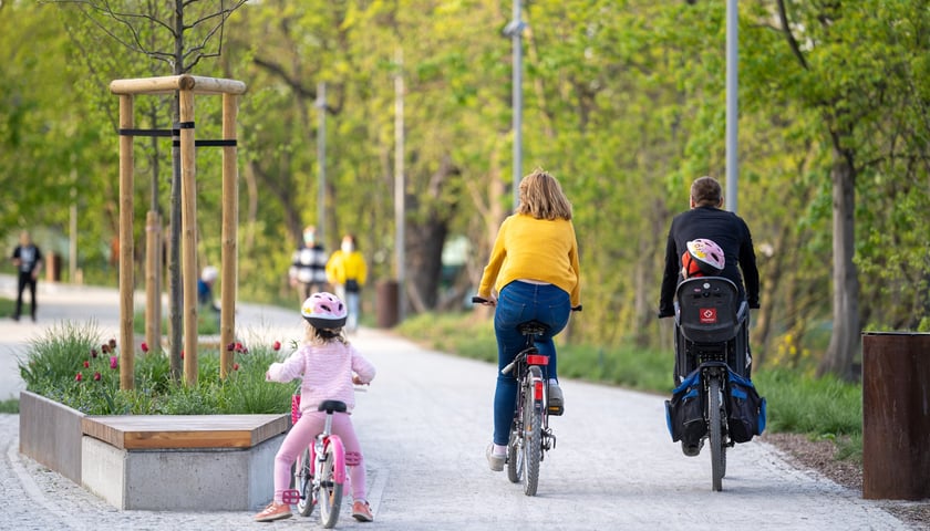 Na zdjęciu rodzina z dziećmi na rowerach