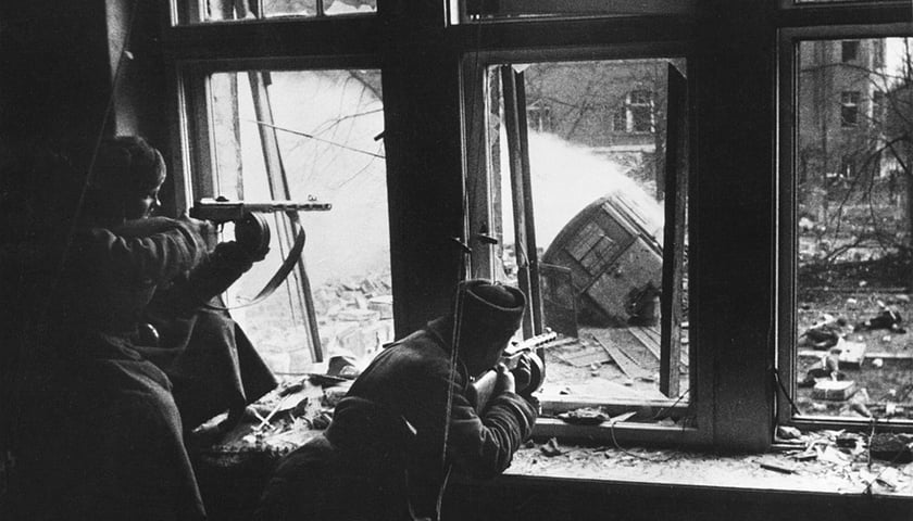 Dwóch żołnierzy Armii Czerwonej na stanowiskach strzeleckich w wybitych oknach kamienicy, Wrocław 1945 rok.