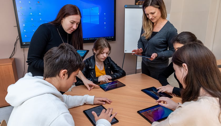 Ze środków UNICEF zakupiono wrocławskim placówkom oświatowym 1900 tabletów i 300 laptopów. Na zdjęciu uczniowie i nauczyciele korzystający z tych urządzeń.