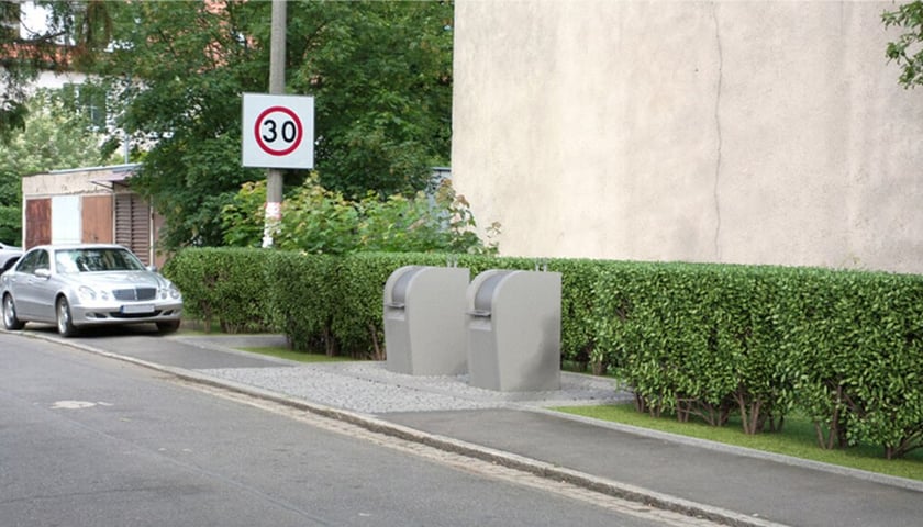 <p>Wizualizacja podziemnych pojemnik&oacute;w na odpady. Silosy ze stalowymi zbiornikami znajdują się pod ziemią, a nad ziemią widać kioski wrzutowe z wrzutnią</p>