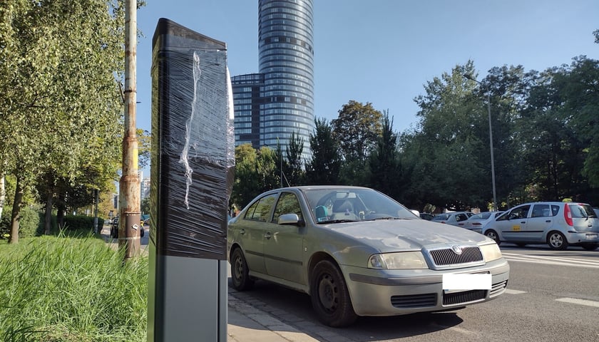 Parkomat, skoda na ulicy Szczęśliwej, na dalszym planie: Sky Tower