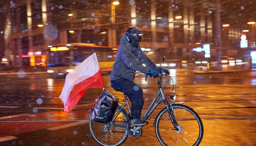 Rowerzysta w zimowy dzień jedzie ul. Oławską. Zdjęcie ilustracyjne. 