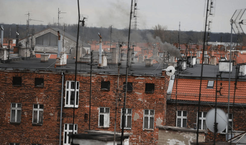 Budynki z cegły na jednym wrocławskich osiedli - widok na dachy i dymiące kominy