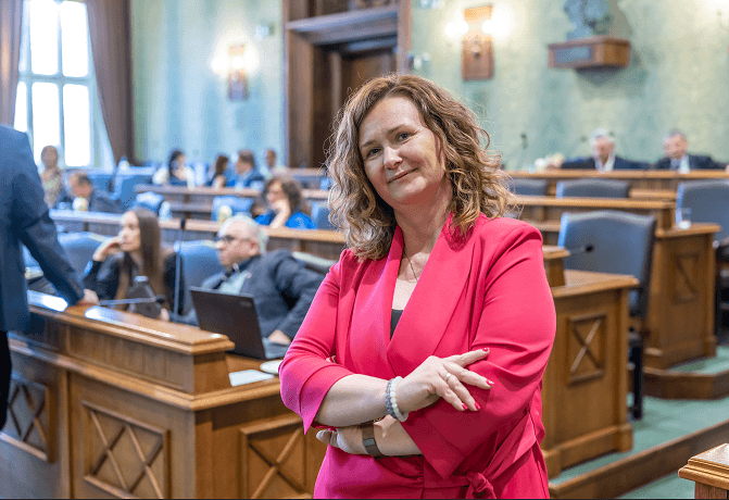Agnieszka Rybczak, przewodnicząca Rady Miejskiej Wrocławia IX kadencji w sali sesyjnej, w tle - inni radni