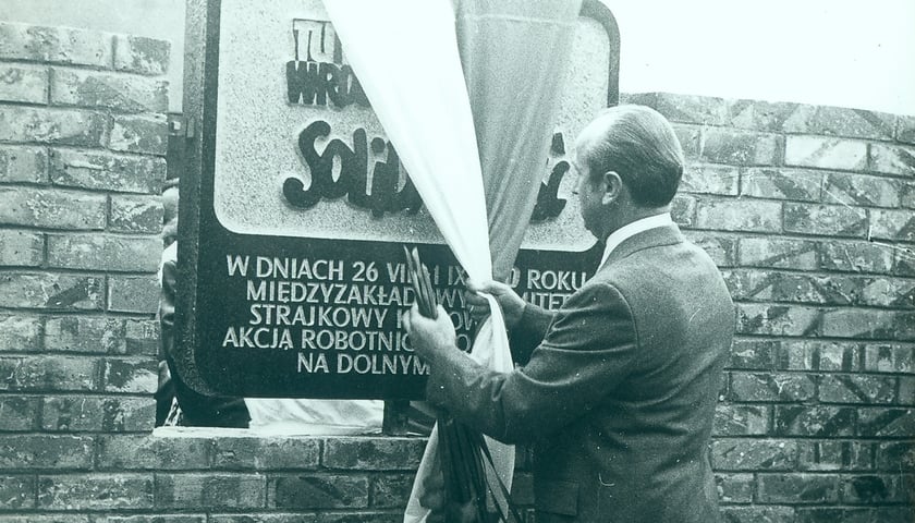 Jerzy Piórkowski odsłania tablicę upamiętniającą strajk w sierpniu 1980 r., umieszczoną na terenie zajezdni autobusowej nr VII przy ul. Grabiszyńskiej we Wrocławiu [na tablicy napis: „Tu rodziła się wrocławska Solidarność…”]