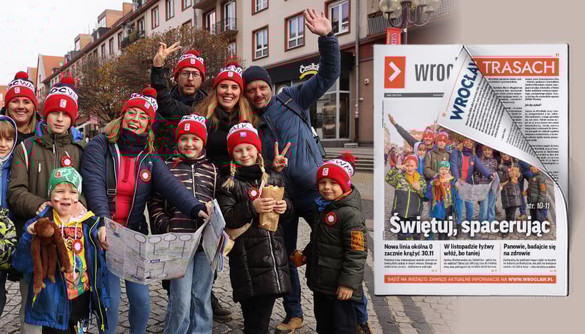 Grupa roześmianych ludzi w jednakowych czapkach z mapami podczas spaceru WrocWalk 2024