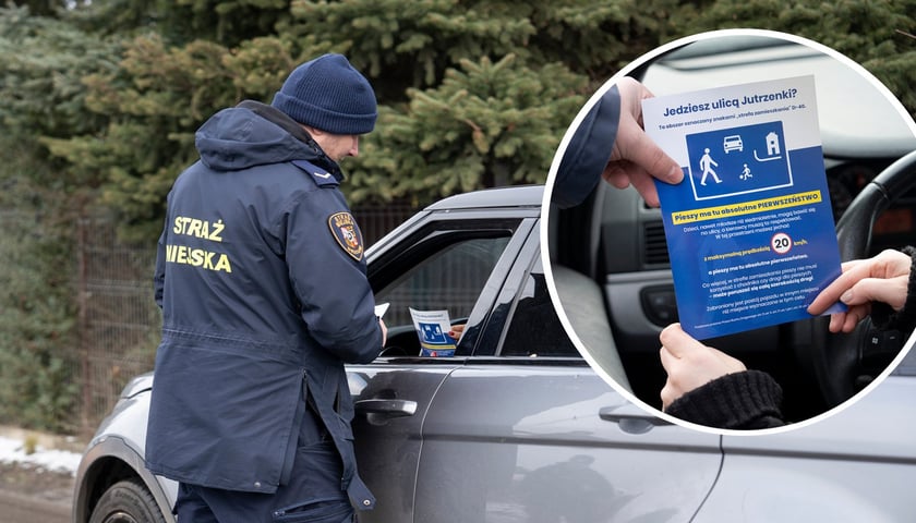 Strażnik miejski przekazuje kierowcy ulotkę informacyjną