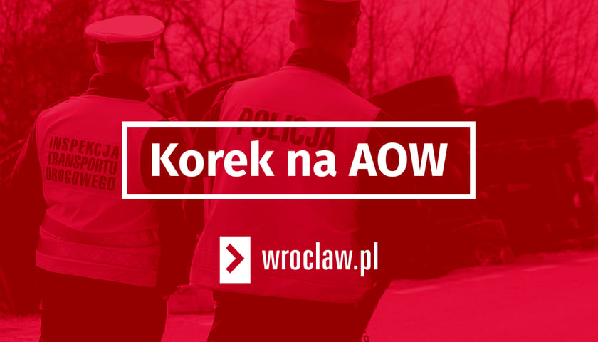 czerwona plansza z napisem "korek na AOW", grafika ilustracyjna