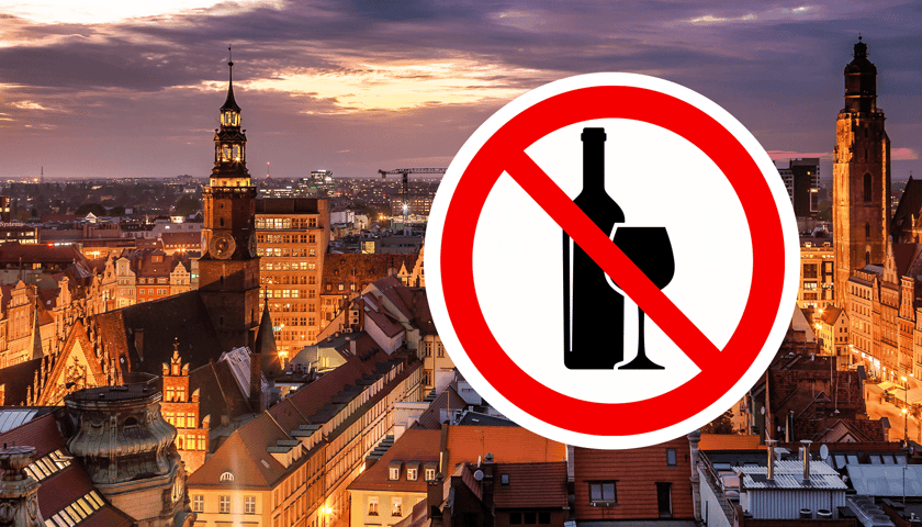 Panorama Wrocławia nocą, w kółku przekreślony symbol alkoholu