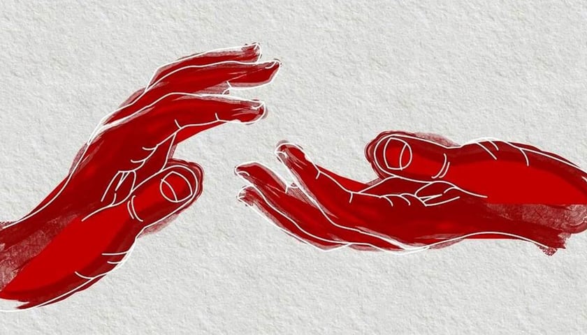 Ludzkie dłonie namalowane na otynkowanej ścianie, zdjęcie ilustracyjne