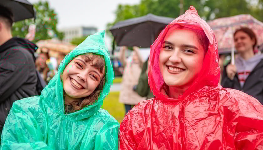 Dwie uśmiechnięte uczestniczki w kurtkach deszczowych podczas drugiego dnia Juwenaliów 2025 #Wrocław Razem w kampusie PWr