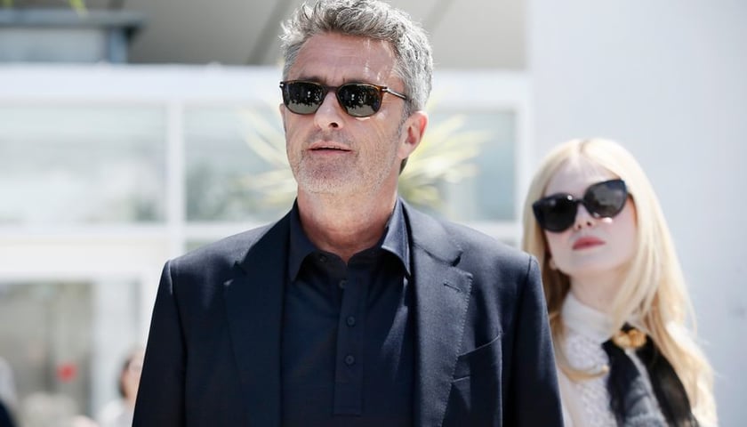 Reżyser Paweł Pawlikowski w okularach słonecznych, w ciemnej marynarce i koszuli