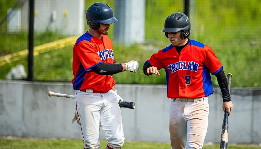 Dwóch zawodników grającej w baseball drużyny Barons Wrocław gratuluje sobie po zdobyciu kolejnych punktów w meczu.