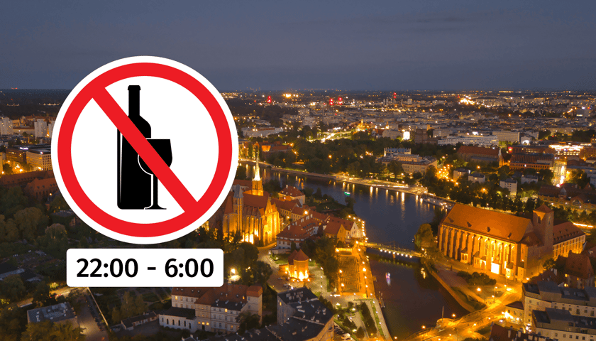 Panorama miasta Wrocławia nocą, w kółku ikona z zakazem spożywania alkoholu