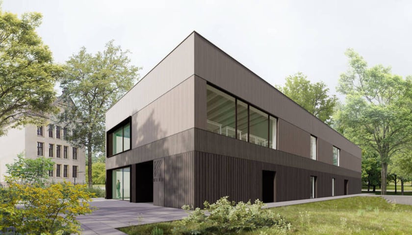 Modelarnia Wydziału Architektury Politechniki Wrocławskiej. Wizualizacja dwupiętrowego budynku w otoczeniu drzew
