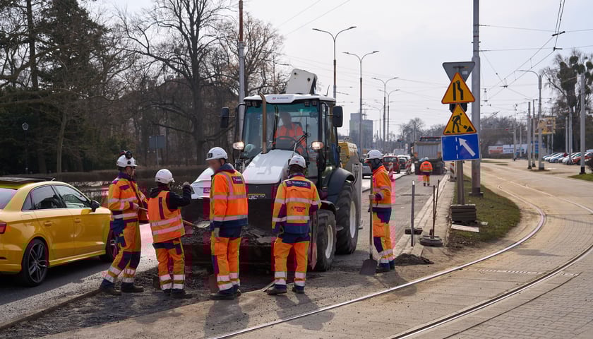 Układanie masy bitumicznej na ulicy Powstańców Śląskich między Orlą a Krzycką