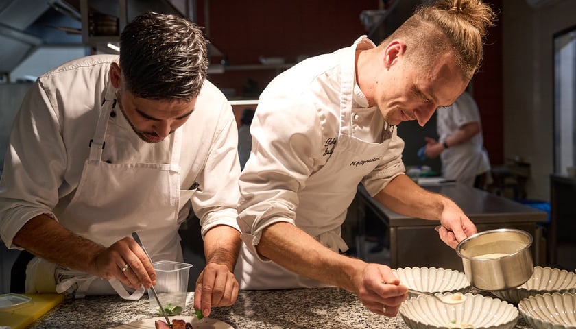 Powiększ obraz: <p>Łukasz Budzik (z prawej), laureat Kulinarnego Grand Prix Wrocławia, szef kuchni restauracji Miedzy Mostami przy pracy</p>