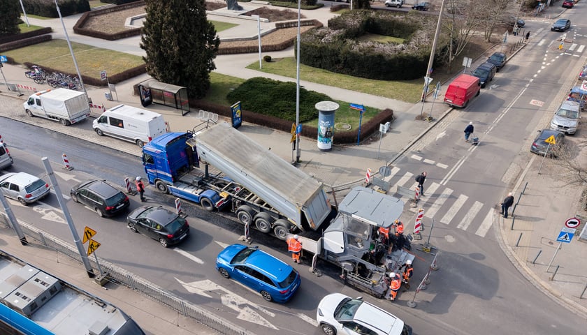 Powiększ obraz: Układanie masy bitumicznej na ulicy Powstańców Śląskich między Orlą a Krzycką