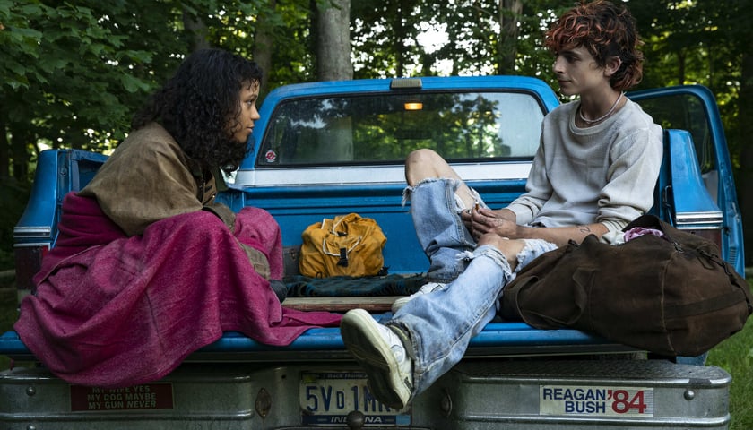 Na zdjęciu aktorzy Timothée Chalamet i Taylor Russell, którzy grają parę siedzą na masce samochodu