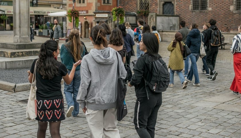 Ludzie spacerujący po rynku we Wrocławiu.